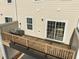 A cozy deck with wood railings provides a private outdoor space, accessible through sliding glass doors at 1414 Excelsior Grand Ave, Durham, NC 27713