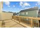 Wooden deck offers neighborhood views on a sunny day with blue skies and scattered clouds at 1414 Excelsior Grand Ave, Durham, NC 27713