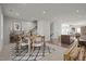 Dining room featuring two bright windows, table set for six, kitchen, and stairs at 1414 Excelsior Grand Ave, Durham, NC 27713
