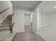 Inviting entryway with hardwood floors, a staircase with wooden banister, and a view into a carpeted room at 1414 Excelsior Grand Ave, Durham, NC 27713