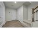 A well-lit entryway featuring vinyl flooring, a white door and carpeted stairs with a wooden banister at 1414 Excelsior Grand Ave, Durham, NC 27713