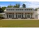 Exterior shot of building featuring a symmetrical facade with a row of inviting glass doors and a green lawn at 1414 Excelsior Grand Ave, Durham, NC 27713