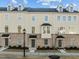 Attractive townhome exterior with bay windows, brick accents, and well-maintained landscaping at 1414 Excelsior Grand Ave, Durham, NC 27713