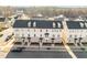 Aerial view of townhomes showcasing their brick facade, black roofs, and neatly landscaped surroundings at 1414 Excelsior Grand Ave, Durham, NC 27713