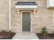 Charming home featuring a stylish front door, black awning, and a brick exterior at 1414 Excelsior Grand Ave, Durham, NC 27713