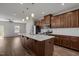 Modern kitchen featuring a center island, stainless steel appliances, and rich brown cabinetry at 1414 Excelsior Grand Ave, Durham, NC 27713