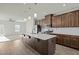 Modern kitchen with a large island, pendant lights, stainless steel appliances, and dark wood cabinets at 1414 Excelsior Grand Ave, Durham, NC 27713