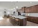 Modern kitchen with stainless steel appliances, a large island with seating, and open to the living room at 1414 Excelsior Grand Ave, Durham, NC 27713