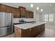 Bright kitchen featuring stainless steel appliances, a large island, and contemporary pendant lighting at 1414 Excelsior Grand Ave, Durham, NC 27713