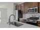 Well-equipped kitchen featuring stainless steel appliances, a large sink, and stylish countertops at 1414 Excelsior Grand Ave, Durham, NC 27713