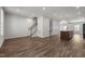 Spacious living area with hardwood floors, leading to the staircase and an open kitchen at 1414 Excelsior Grand Ave, Durham, NC 27713