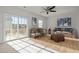 Bright living room featuring stylish furnishings, artwork, and sliding glass doors to a balcony at 1414 Excelsior Grand Ave, Durham, NC 27713