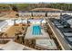 Aerial view of a community pool area including a full sized pool, kiddie pool, and gathering spaces at 1414 Excelsior Grand Ave, Durham, NC 27713