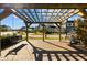 Exterior image showing neighborhood swings under a pergola with manicured landscaping in a walkable community at 1414 Excelsior Grand Ave, Durham, NC 27713