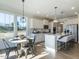 Bright, modern kitchen with stainless steel appliances, center island, and adjacent dining area at 142 Sugar Pine Drive, Franklinton, NC 27525
