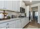 Modern kitchen with stainless steel appliances, ample counter space, and bar stool seating at 142 Sugar Pine Drive, Franklinton, NC 27525