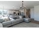 Spacious open-concept living room with a large sofa and views into the modern kitchen at 142 Sugar Pine Drive, Franklinton, NC 27525