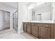 Bright bathroom featuring a double vanity, framed mirror, and glass-enclosed shower at 1987 Meadowview Dr, Graham, NC 27253