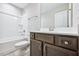 Well-lit bathroom featuring a tub and shower combination and stylish vanity at 1987 Meadowview Dr, Graham, NC 27253