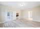 Bedroom with new floors, neutral paint, base molding and glass paneled doors to back porch at 1987 Meadowview Dr, Graham, NC 27253