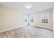 Bedroom with new floors, neutral paint, base molding and large windows overlooking the backyard at 1987 Meadowview Dr, Graham, NC 27253