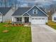 Charming single-Gathering home featuring a two-car garage, well-manicured lawn, and inviting front porch at 1987 Meadowview Dr, Graham, NC 27253