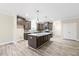 Modern kitchen with an island, stainless steel appliances, granite countertops, and ample dark wood cabinetry at 1987 Meadowview Dr, Graham, NC 27253