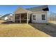 Back of home featuring a screened porch and a well-maintained yard at 1987 Meadowview Dr, Graham, NC 27253