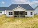 Back of home featuring a screened porch and a well-maintained yard at 1987 Meadowview Dr, Graham, NC 27253