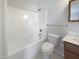 Clean, white bathroom featuring a shower-tub combo and classic fixtures at 207 Lawrence St, Fuquay Varina, NC 27526