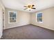 Spacious bedroom with a ceiling fan and natural light from two large windows at 207 Lawrence St, Fuquay Varina, NC 27526