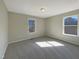 Bright bedroom featuring a large window, soft carpet, and ample space at 207 Lawrence St, Fuquay Varina, NC 27526