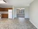 Open kitchen with ample counter space, white appliances, and durable tile flooring at 207 Lawrence St, Fuquay Varina, NC 27526