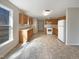 Open kitchen with ample counter space, white appliances, and durable tile flooring at 207 Lawrence St, Fuquay Varina, NC 27526