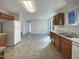 Open kitchen with ample counter space, white appliances, and durable tile flooring at 207 Lawrence St, Fuquay Varina, NC 27526