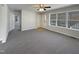 Bright living room featuring soft carpet, a ceiling fan, and lots of light at 207 Lawrence St, Fuquay Varina, NC 27526