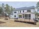 Large backyard with wooden deck and playground surrounded by trees at 240 Seaforth Landing Dr, Pittsboro, NC 27312