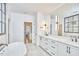 Bright bathroom with double sink vanity, soaking tub, and modern finishes at 240 Seaforth Landing Dr, Pittsboro, NC 27312