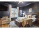 Cozy bedroom with dark walls, a large window, and a comfortable-looking bed with many pillows at 240 Seaforth Landing Dr, Pittsboro, NC 27312