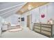 Cozy bedroom with sloped ceilings, charming decor, and comfortable furnishings at 240 Seaforth Landing Dr, Pittsboro, NC 27312