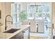 Bright dining room with a modern chandelier and large windows overlooking a backyard landscape at 240 Seaforth Landing Dr, Pittsboro, NC 27312