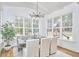 The bright dining room features large windows overlooking the play area, exposed beam and a stylish chandelier at 240 Seaforth Landing Dr, Pittsboro, NC 27312