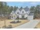 Beautiful two-story home featuring a three-car garage, white siding, brick accents, and a well-maintained yard at 240 Seaforth Landing Dr, Pittsboro, NC 27312