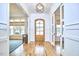 Bright foyer with wood floors, a decorative front door, and views into the living and dining spaces at 240 Seaforth Landing Dr, Pittsboro, NC 27312