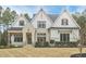 Charming two-story home with brick and white siding, gabled roof, manicured landscaping, and a welcoming front porch at 240 Seaforth Landing Dr, Pittsboro, NC 27312