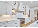 This modern kitchen has white cabinets, stainless steel appliances and a stylish herringbone backsplash at 240 Seaforth Landing Dr, Pittsboro, NC 27312