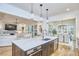 Open concept kitchen with island sink, stainless steel appliances, connecting to the living room and dining room at 240 Seaforth Landing Dr, Pittsboro, NC 27312