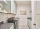 Functional laundry room with modern appliances, stylish tile flooring, and ample counter space at 240 Seaforth Landing Dr, Pittsboro, NC 27312