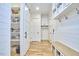 Functional mud room with storage, coat hooks, built-in bench, and shiplap walls for an organized entryway at 240 Seaforth Landing Dr, Pittsboro, NC 27312