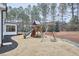 Wooden playground set with slide, swings, and climbing area in backyard at 240 Seaforth Landing Dr, Pittsboro, NC 27312